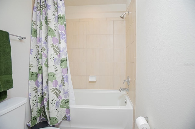 bathroom featuring toilet and shower / bath combo with shower curtain