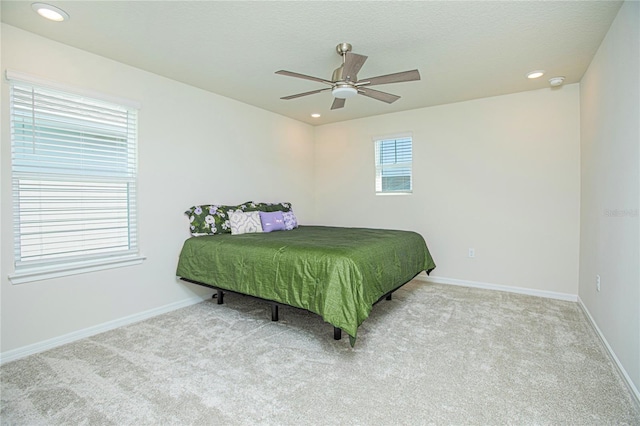 carpeted bedroom featuring ceiling fan, a textured ceiling, recessed lighting, and baseboards