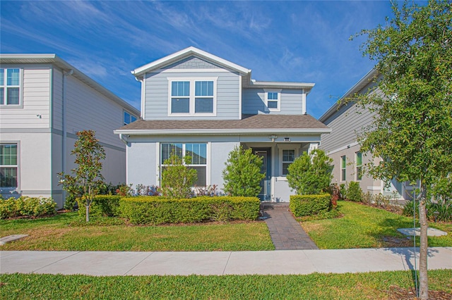 view of front of home featuring a front lawn and roof with shingles