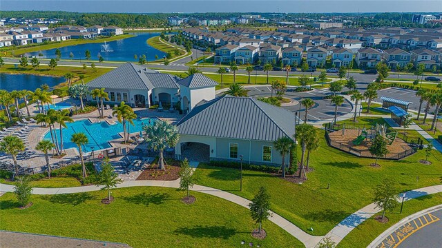 drone / aerial view with a residential view and a water view