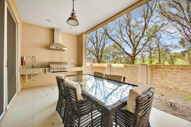 view of patio featuring a fenced backyard, a sink, and area for grilling