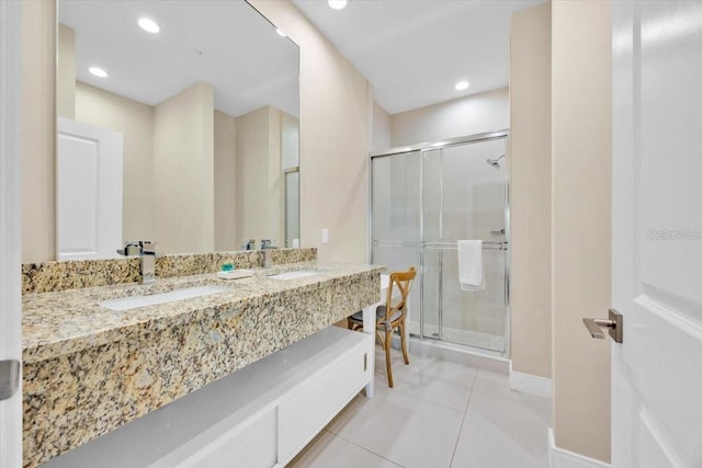 full bathroom with a sink, a shower stall, and tile patterned floors