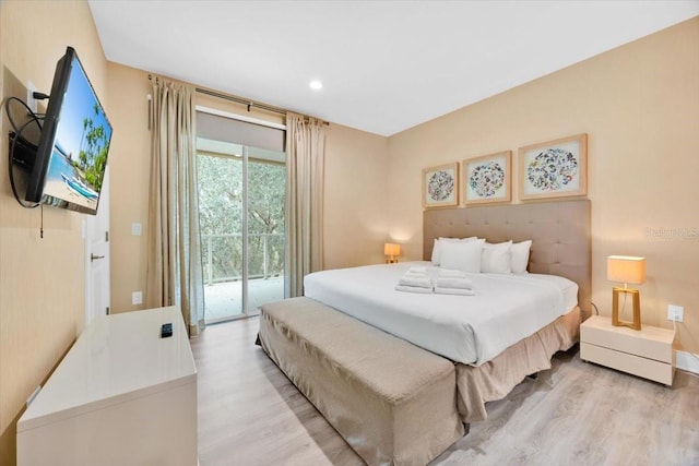 bedroom featuring light wood-type flooring and access to outside