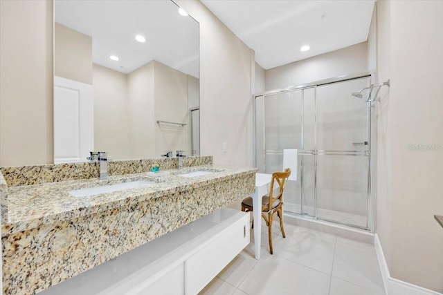 bathroom with recessed lighting, tile patterned flooring, a sink, and a shower stall