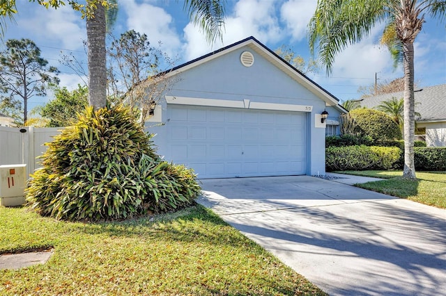 garage with driveway and fence