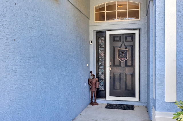 doorway to property with stucco siding