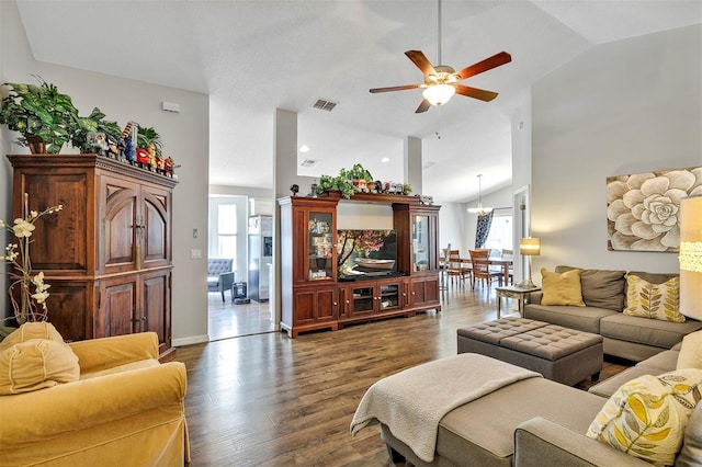 living room featuring ceiling fan with notable chandelier, high vaulted ceiling, wood finished floors, and visible vents