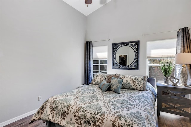 bedroom with lofted ceiling, ceiling fan, baseboards, and wood finished floors