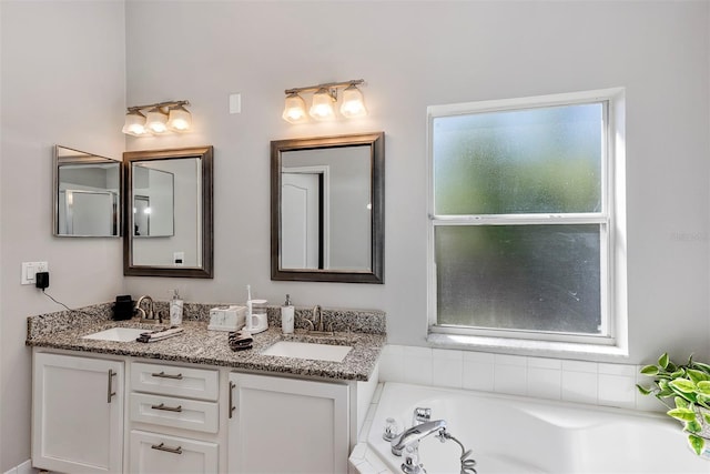 full bathroom featuring a wealth of natural light, a garden tub, and a sink