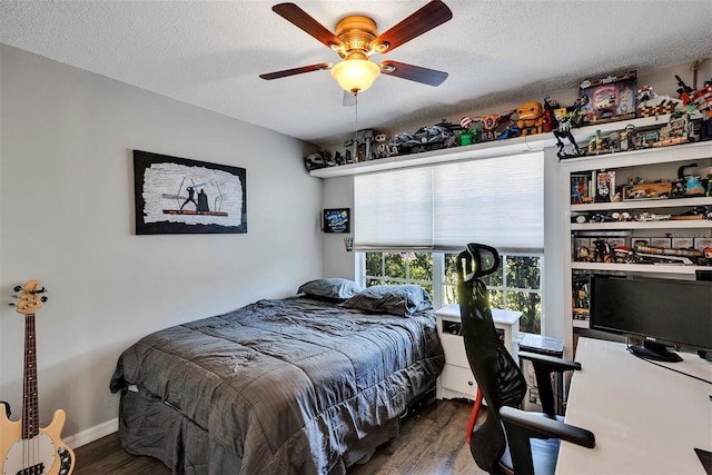 bedroom with ceiling fan, a textured ceiling, baseboards, and wood finished floors