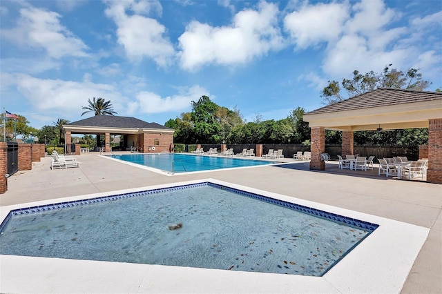 pool featuring fence, a patio, and a gazebo