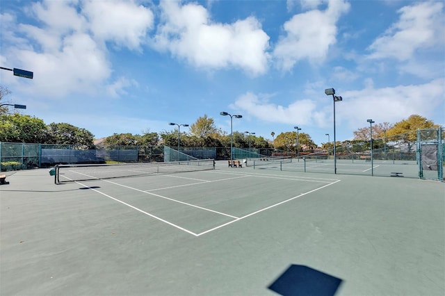 view of sport court featuring community basketball court and fence