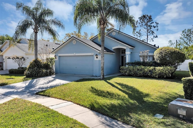 ranch-style house featuring a garage, concrete driveway, a front yard, and stucco siding