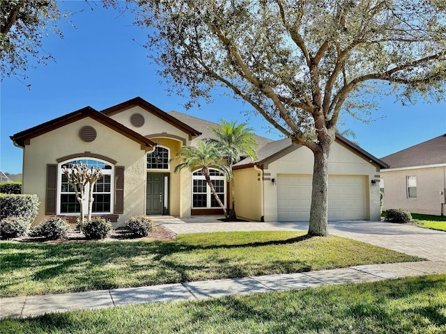 view of front of home featuring a front yard and a garage