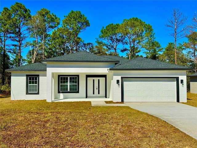 view of front of property featuring a front lawn and a garage