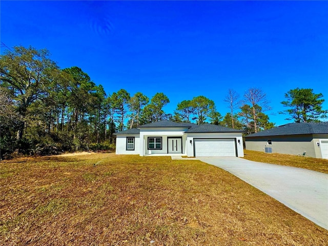 view of front of home with a front yard and a garage