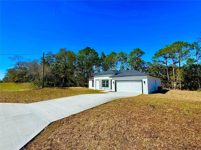 ranch-style house featuring a front yard and a garage