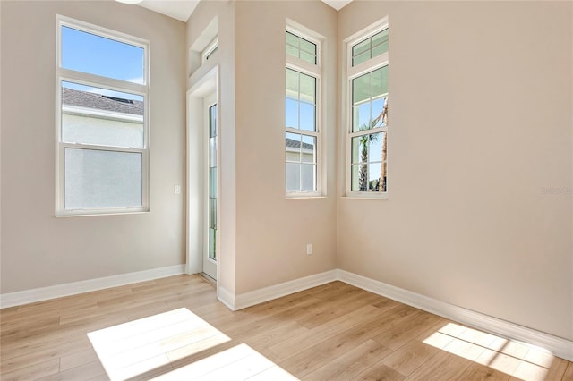 empty room featuring light hardwood / wood-style flooring and a wealth of natural light