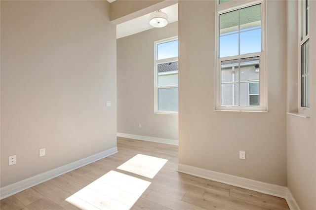 empty room with light hardwood / wood-style floors