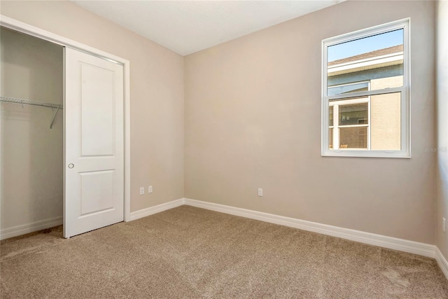 unfurnished bedroom featuring carpet floors and a closet