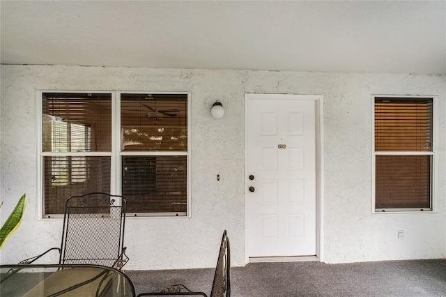 view of exterior entry with stucco siding