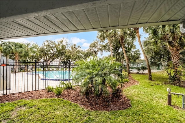 view of yard featuring a community pool and fence