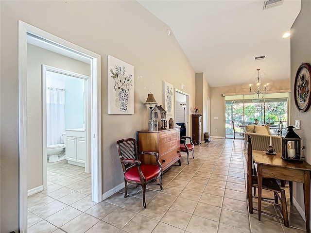 tiled dining room featuring a notable chandelier and high vaulted ceiling