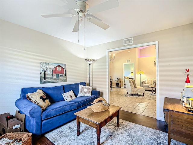 living room with hardwood / wood-style flooring and ceiling fan