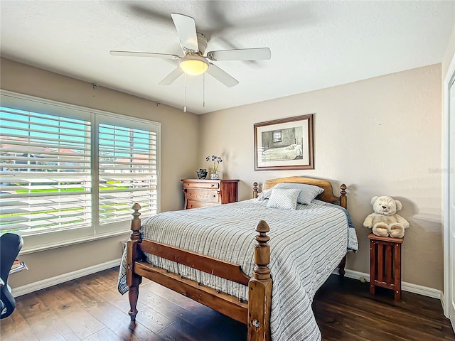 bedroom with ceiling fan and dark wood-type flooring