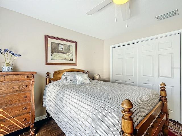 bedroom with a closet, dark hardwood / wood-style floors, and ceiling fan