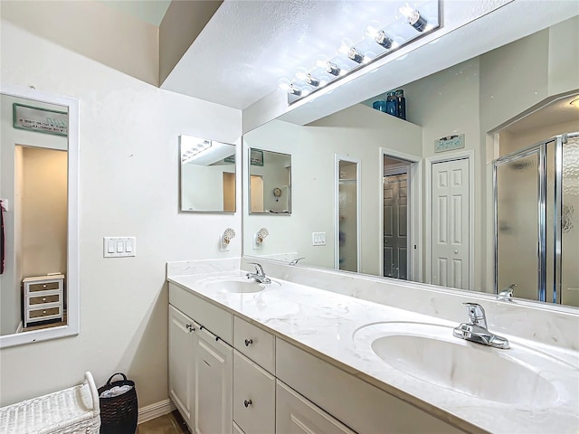 bathroom with an enclosed shower and vanity