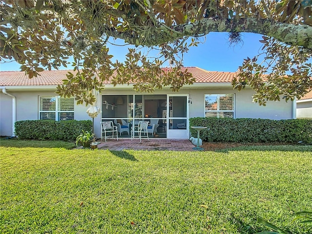 view of front of property featuring a sunroom and a front yard