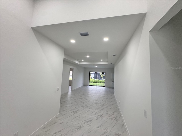 spare room featuring a raised ceiling