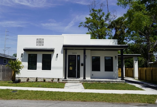 2604 E 11th Ave, Tampa, FL 33605 - view of front of home featuring stucco siding, covered porch, and fence