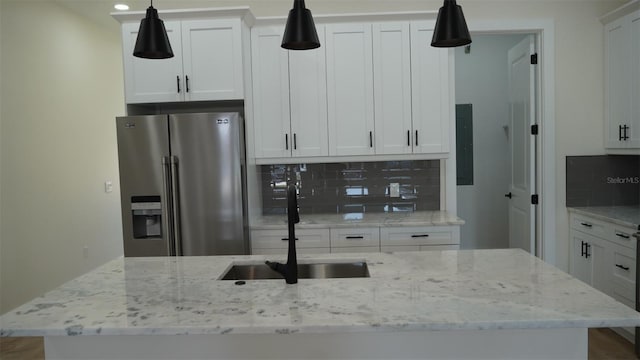 2604 E 11th Ave, Tampa, FL 33605 - kitchen featuring stainless steel fridge, a sink, light stone countertops, and decorative backsplash