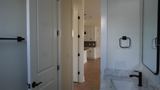 2604 E 11th Ave, Tampa, FL 33605 - bathroom featuring wood finished floors and a sink