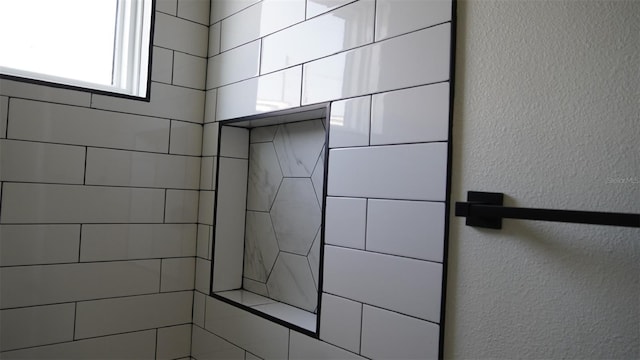 2604 E 11th Ave, Tampa, FL 33605 - full bathroom featuring a textured wall and a tile shower