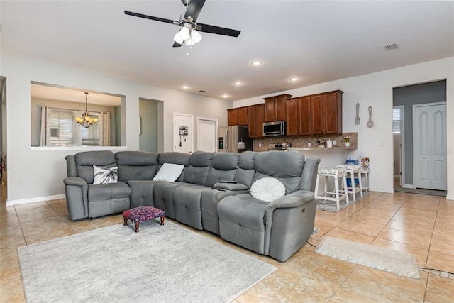 living room with a wealth of natural light, recessed lighting, visible vents, and baseboards