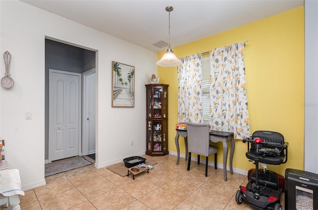 office area featuring light tile patterned floors, visible vents, and baseboards