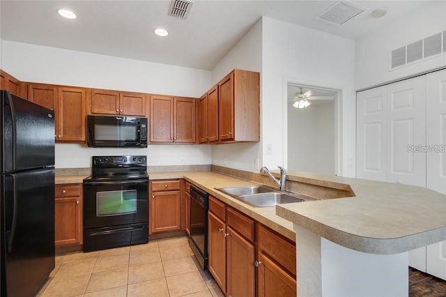 kitchen with visible vents, a peninsula, light countertops, black appliances, and a sink