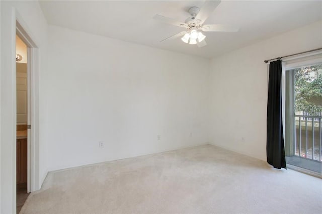 empty room with a ceiling fan and light carpet