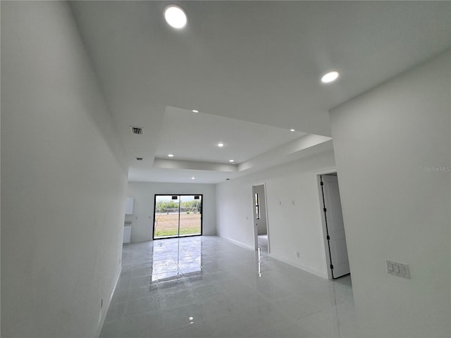 empty room featuring a raised ceiling