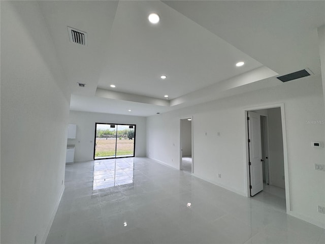 spare room with a tray ceiling