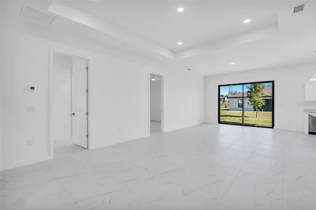 3924 NW 38th St, Cape Coral, FL 33993 - unfurnished living room with a raised ceiling, recessed lighting, and light marble finish flooring