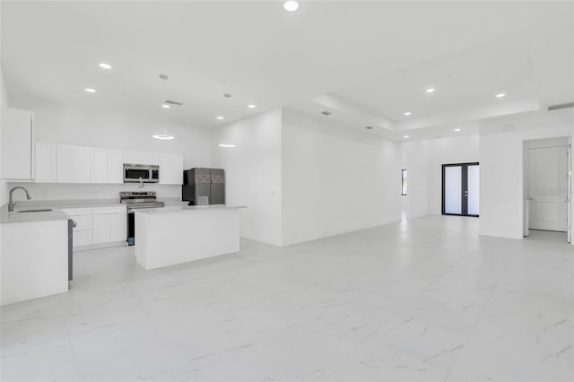 3924 NW 38th St, Cape Coral, FL 33993 - unfurnished living room with recessed lighting, light marble finish flooring, and a tray ceiling