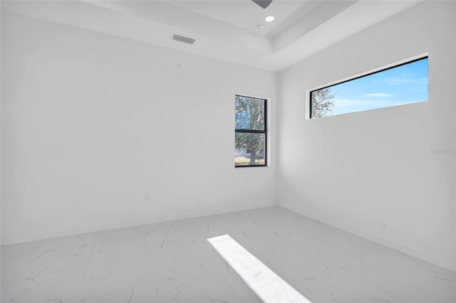3924 NW 38th St, Cape Coral, FL 33993 - spare room with marble look tiles, a raised ceiling, and recessed lighting