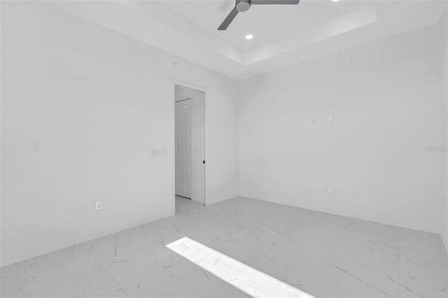 3924 NW 38th St, Cape Coral, FL 33993 - empty room with marble finish flooring, a tray ceiling, ceiling fan, and recessed lighting