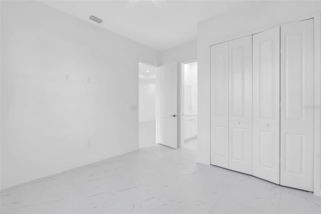 3924 NW 38th St, Cape Coral, FL 33993 - unfurnished bedroom featuring light marble finish flooring and a closet