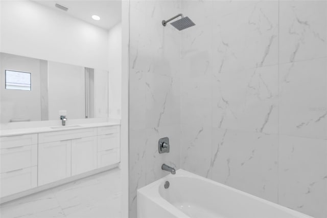 3924 NW 38th St, Cape Coral, FL 33993 - bathroom featuring vanity, marble look tiles, and tub / shower combination