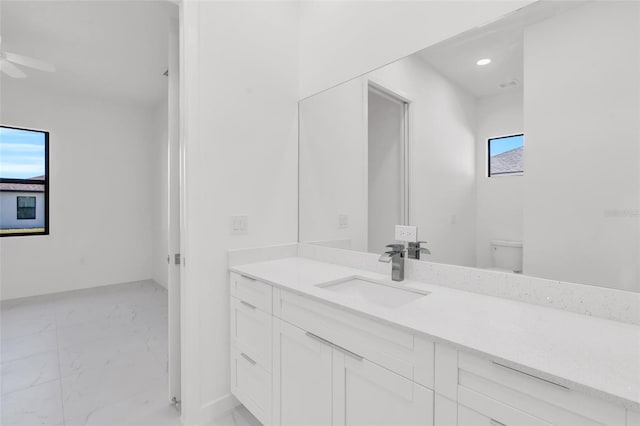 3924 NW 38th St, Cape Coral, FL 33993 - bathroom featuring marble look tiles, vanity, a ceiling fan, and recessed lighting